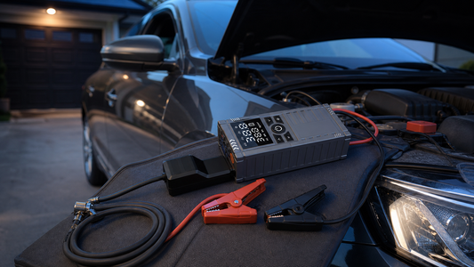KingTool jump starter with air compressor beside a parked car